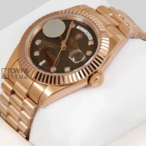 "Rose Gold Watch with Chocolate Brown Dial, Stone Numerals, and Fluted Bezel "