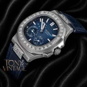 Silver Watch with Stone Bezel, Blue Dial, and Leather Strap