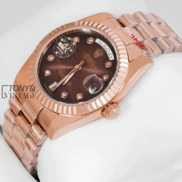 Rose Gold Watch with Chocolate Brown Dial, Stone Numerals, and Fluted Bezel