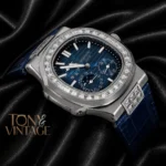 Silver Watch with Stone Bezel, Blue Dial, and Leather Strap